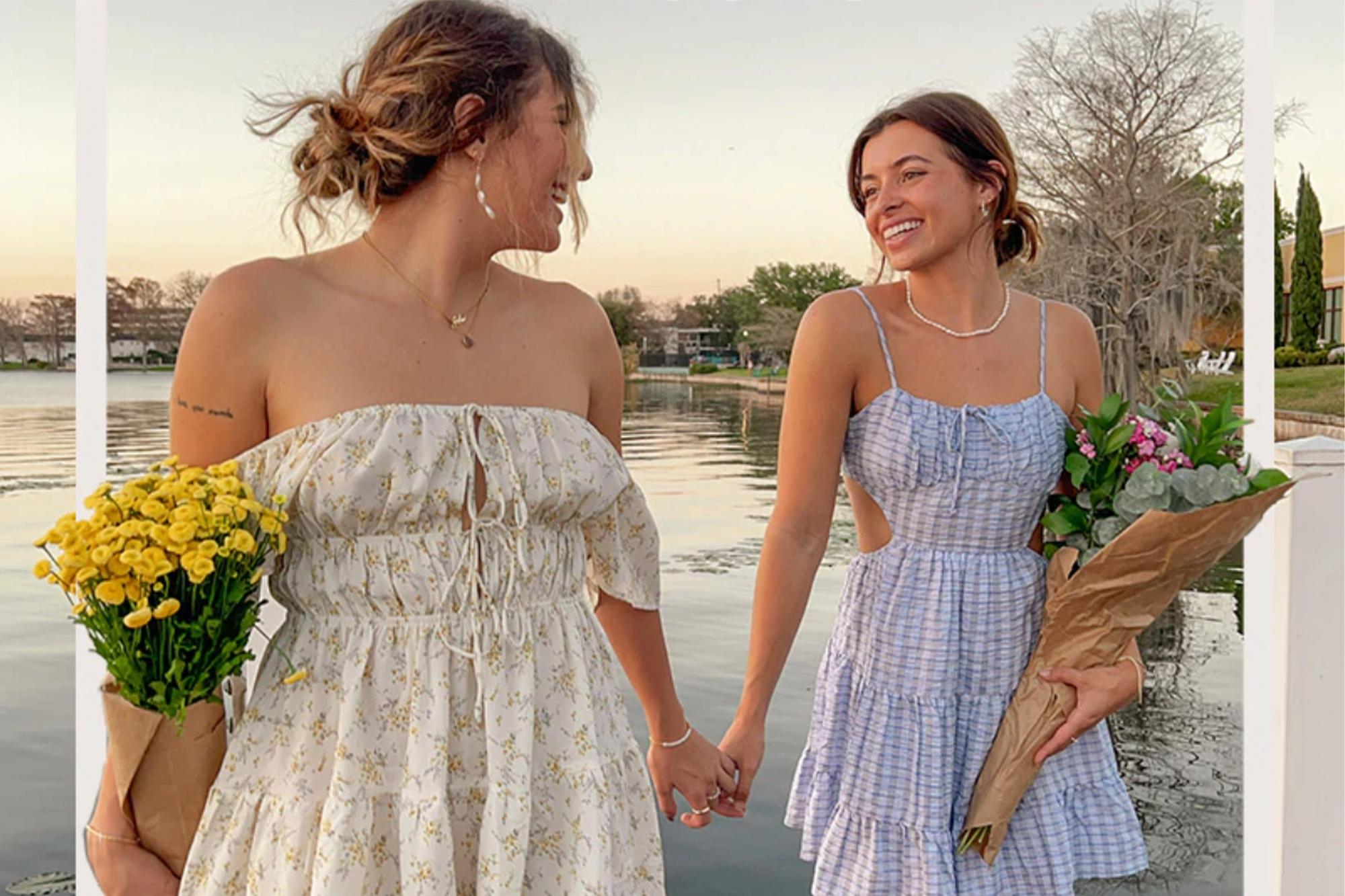 Women holding hands wearing summer dresses