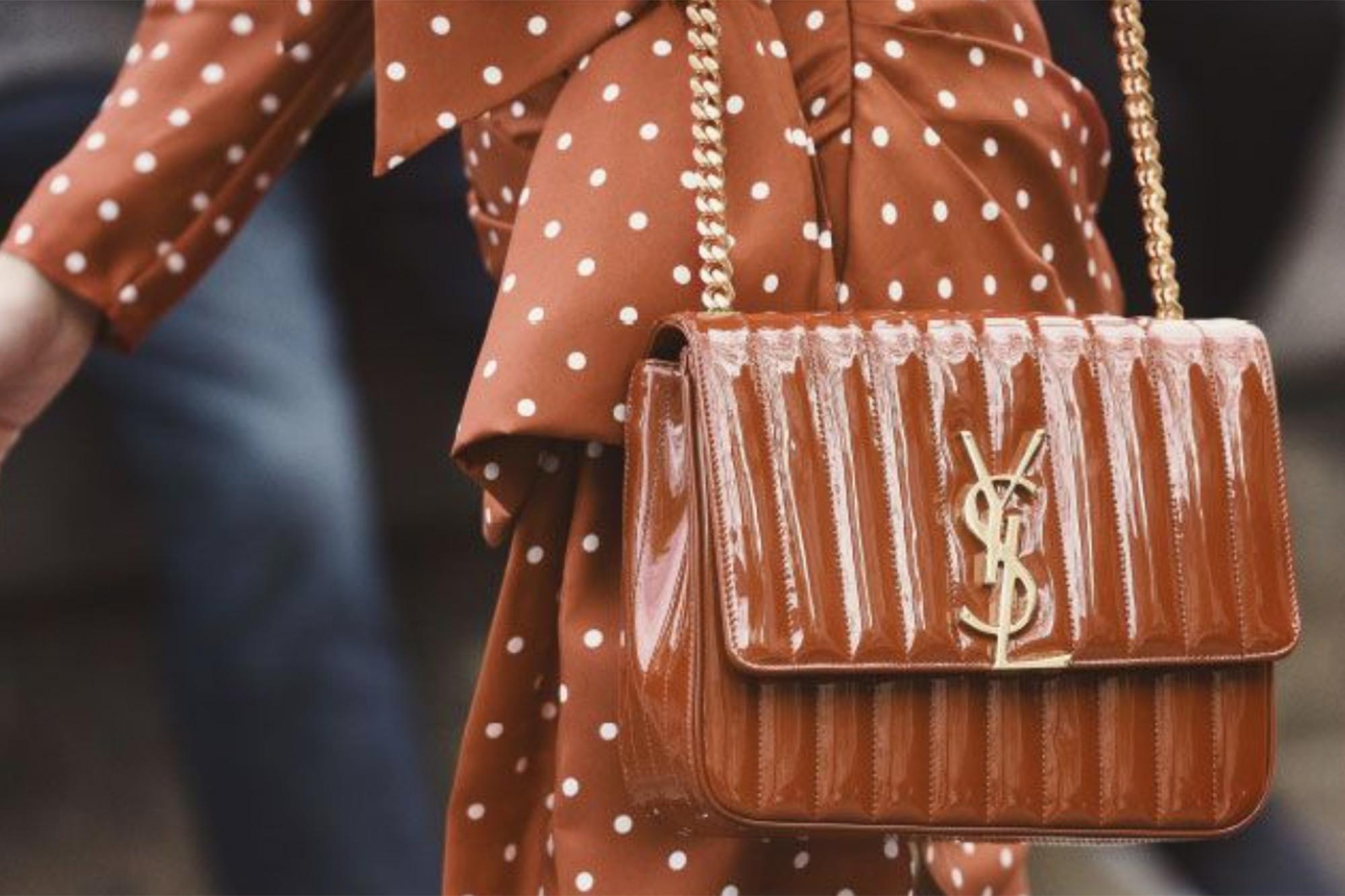 Woman holding brown YSL bag