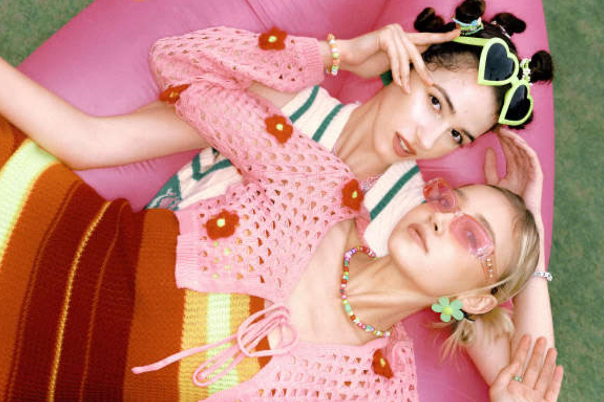 Two women laying next to each other in retro outfit