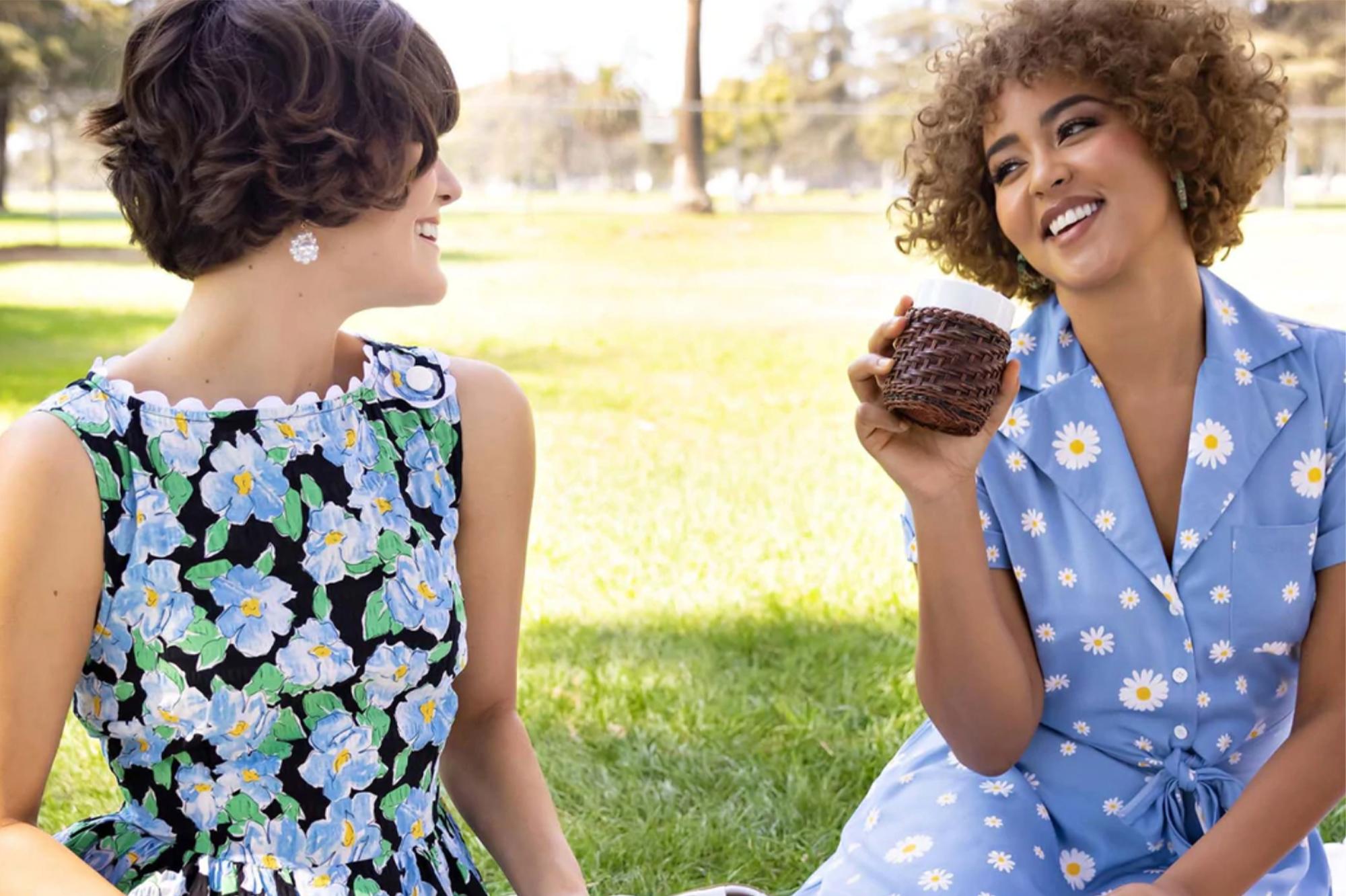 Two women wearing 80s dresses