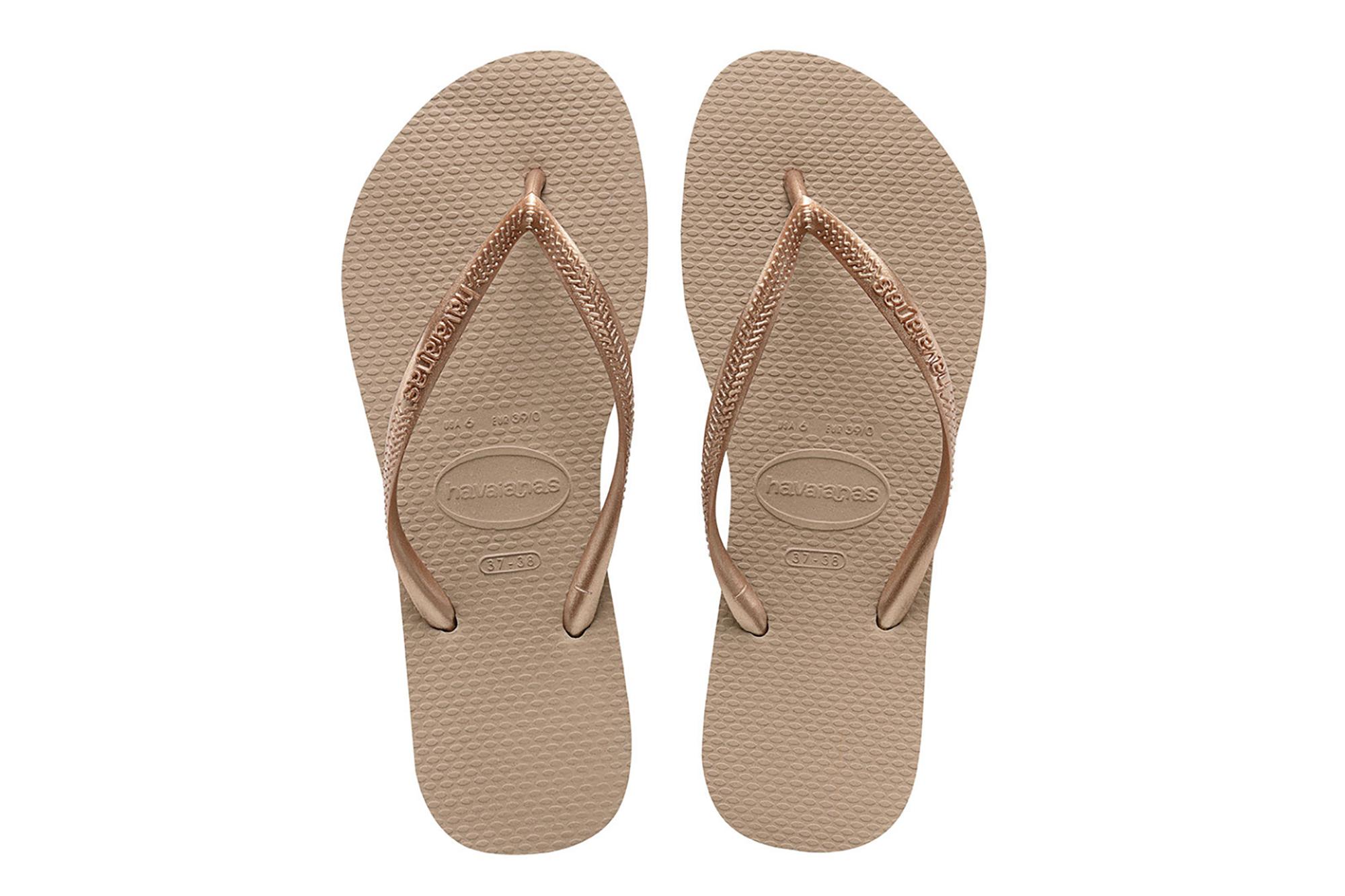 A pair of rose gold flip flops