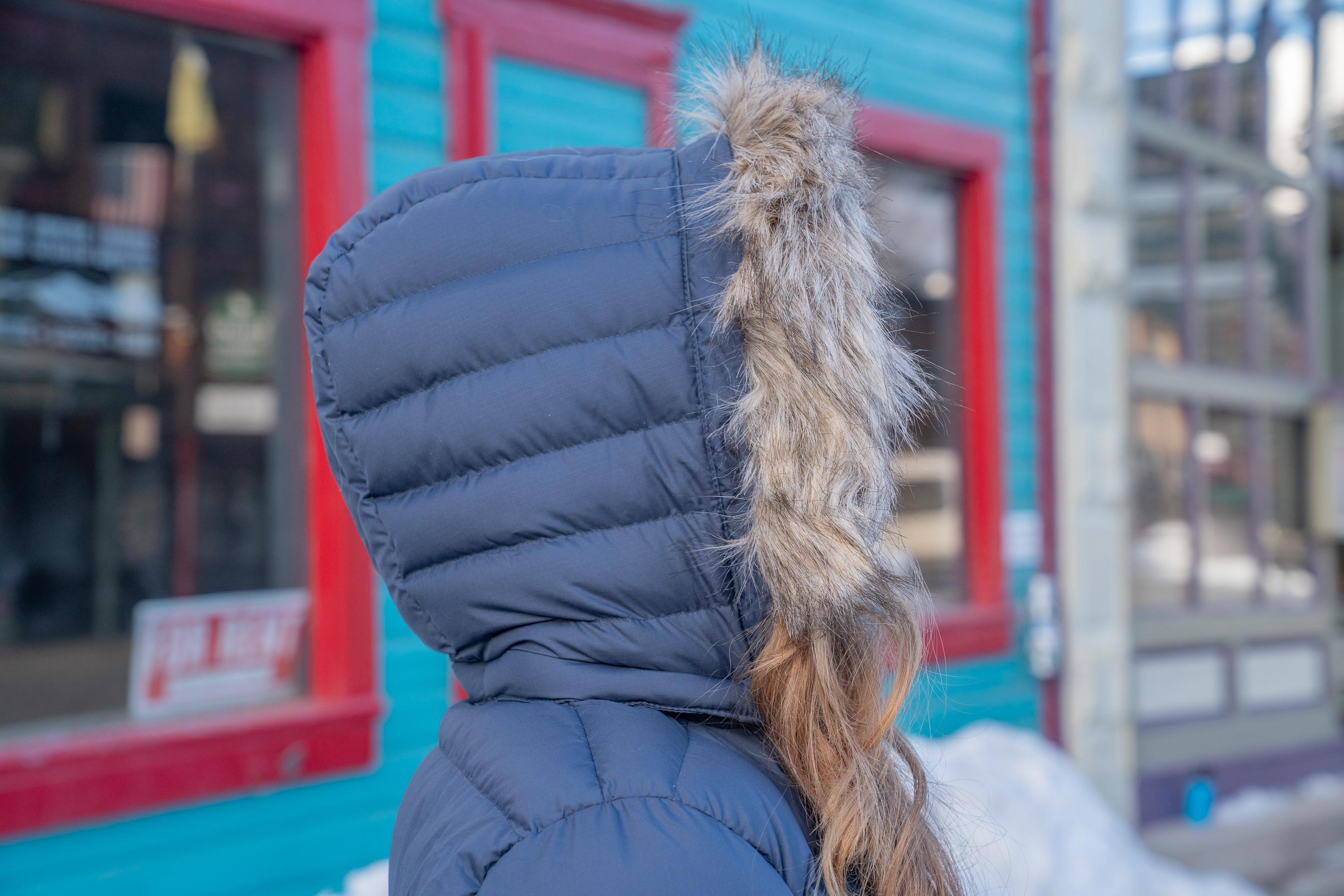 Two women walking in winter coats down the main street in a mountain town