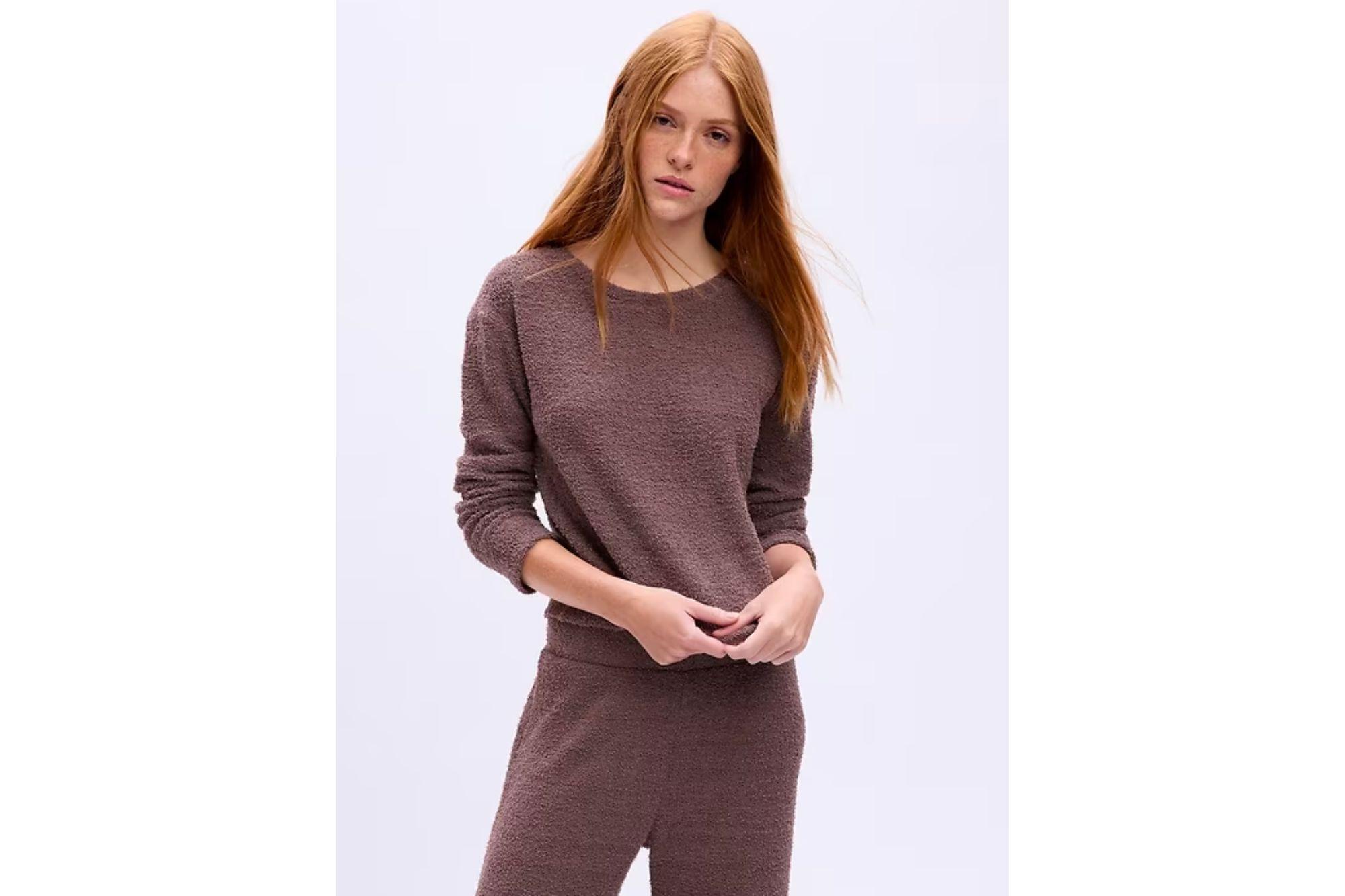 Woman in a brown loungewear top.