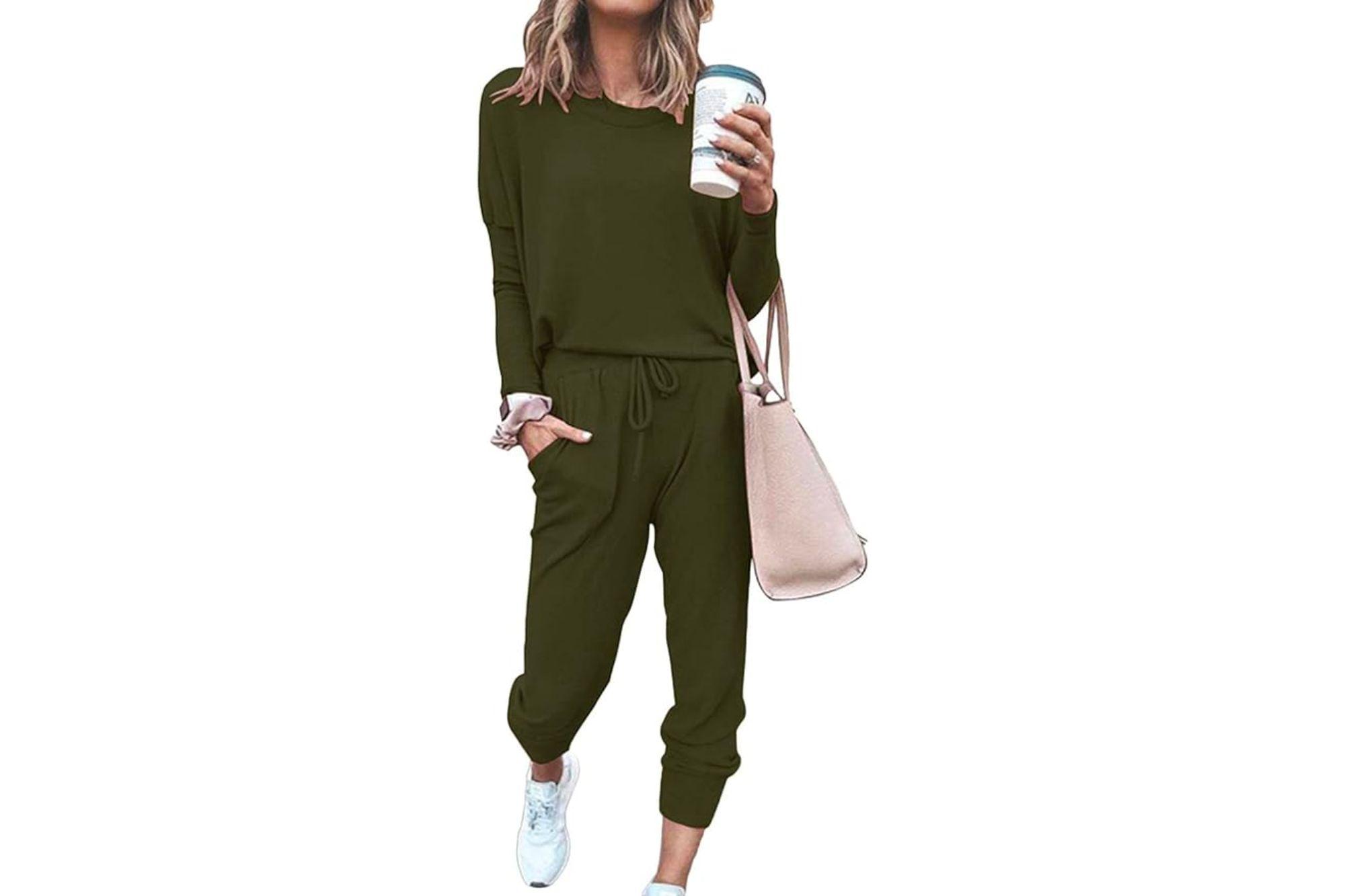 Woman with a bag, cup of coffee, wearing a green loungewear set.