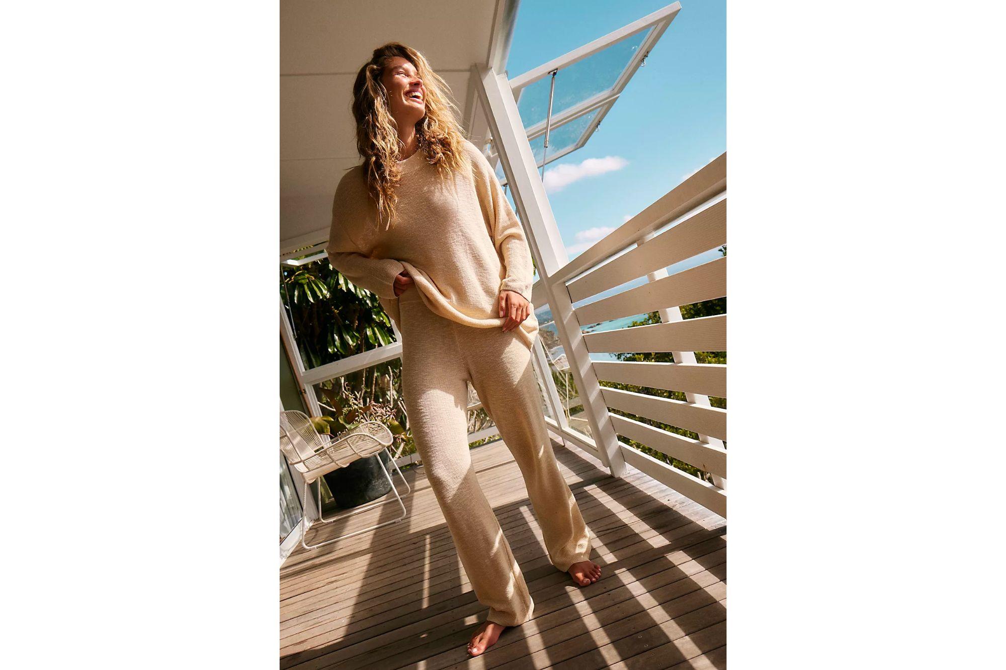 Woman in a cream colored slouchy loungewear set.