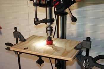 To build the auxiliary drum sanding table, first cut a piece of plywood to the exact dimensions of the drill press table. The, align the plywood