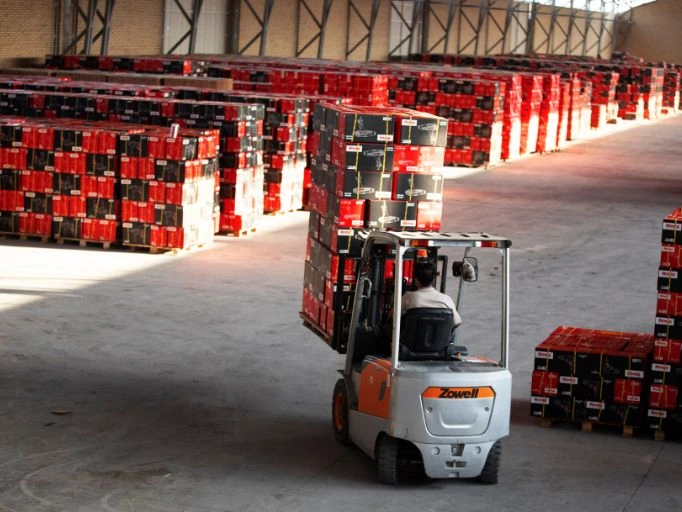 A Lift-truck carrying boxes of tools in a tool warehouse