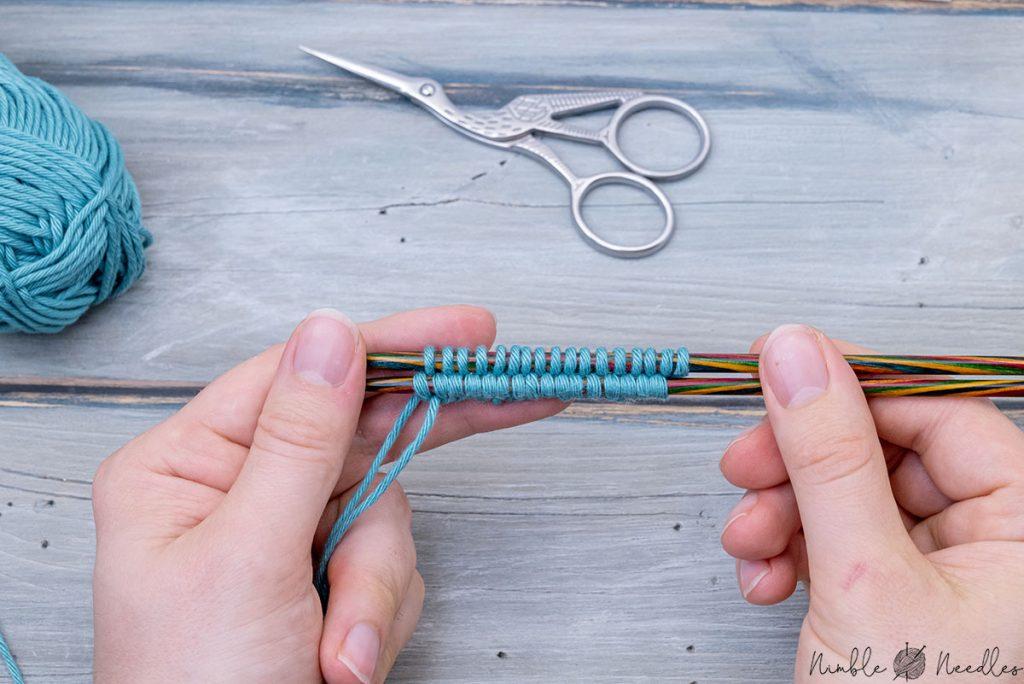 someone holding up a two needle cast on with their fingers