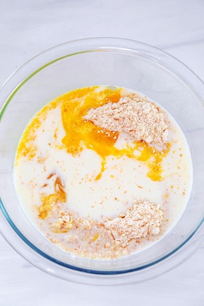 Muffin mix with egg and milk added in mixing bowl