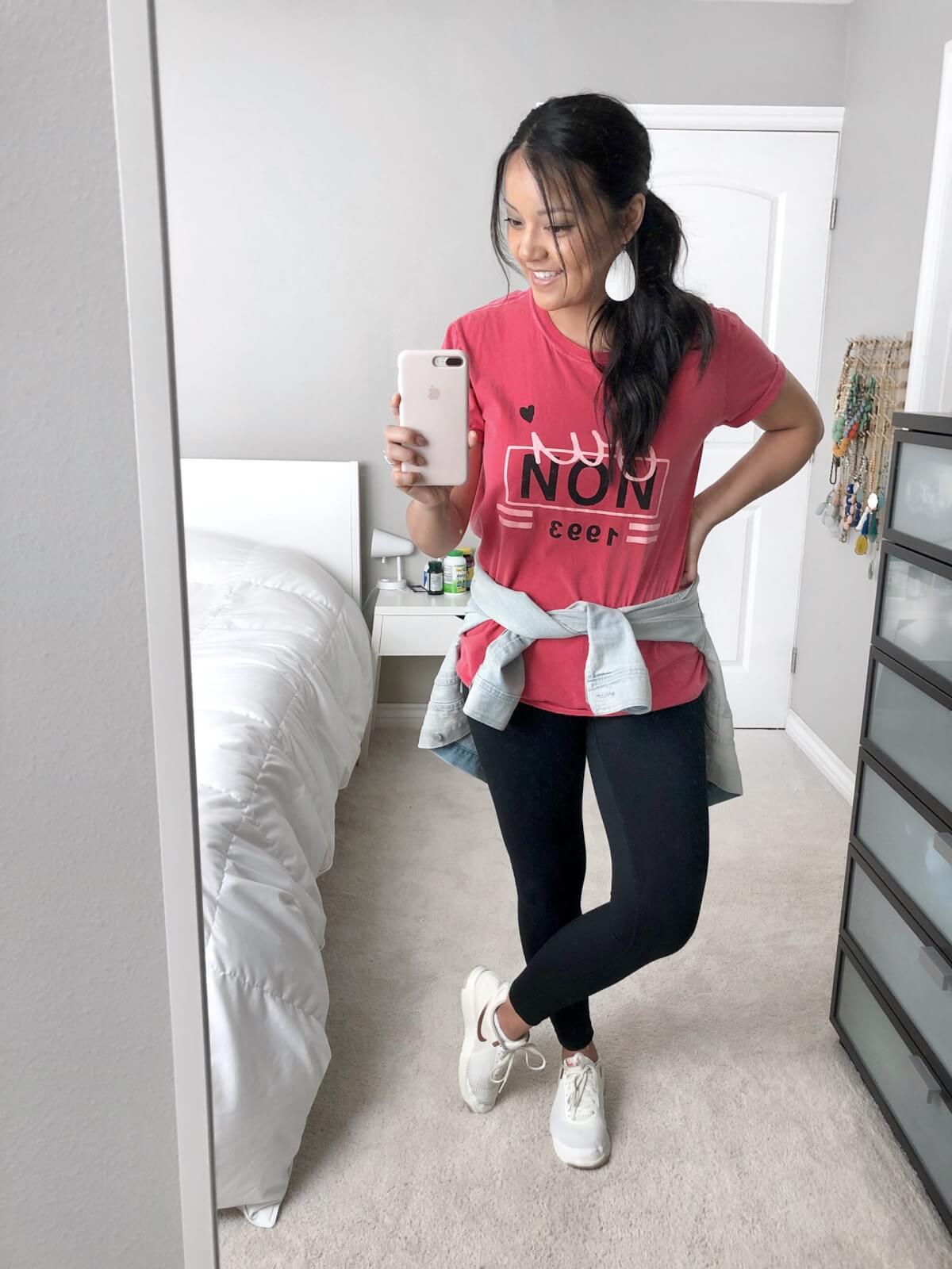 denim jacket outfit: denim jacket + pink tee + black leggings + white sneakers + white earrings