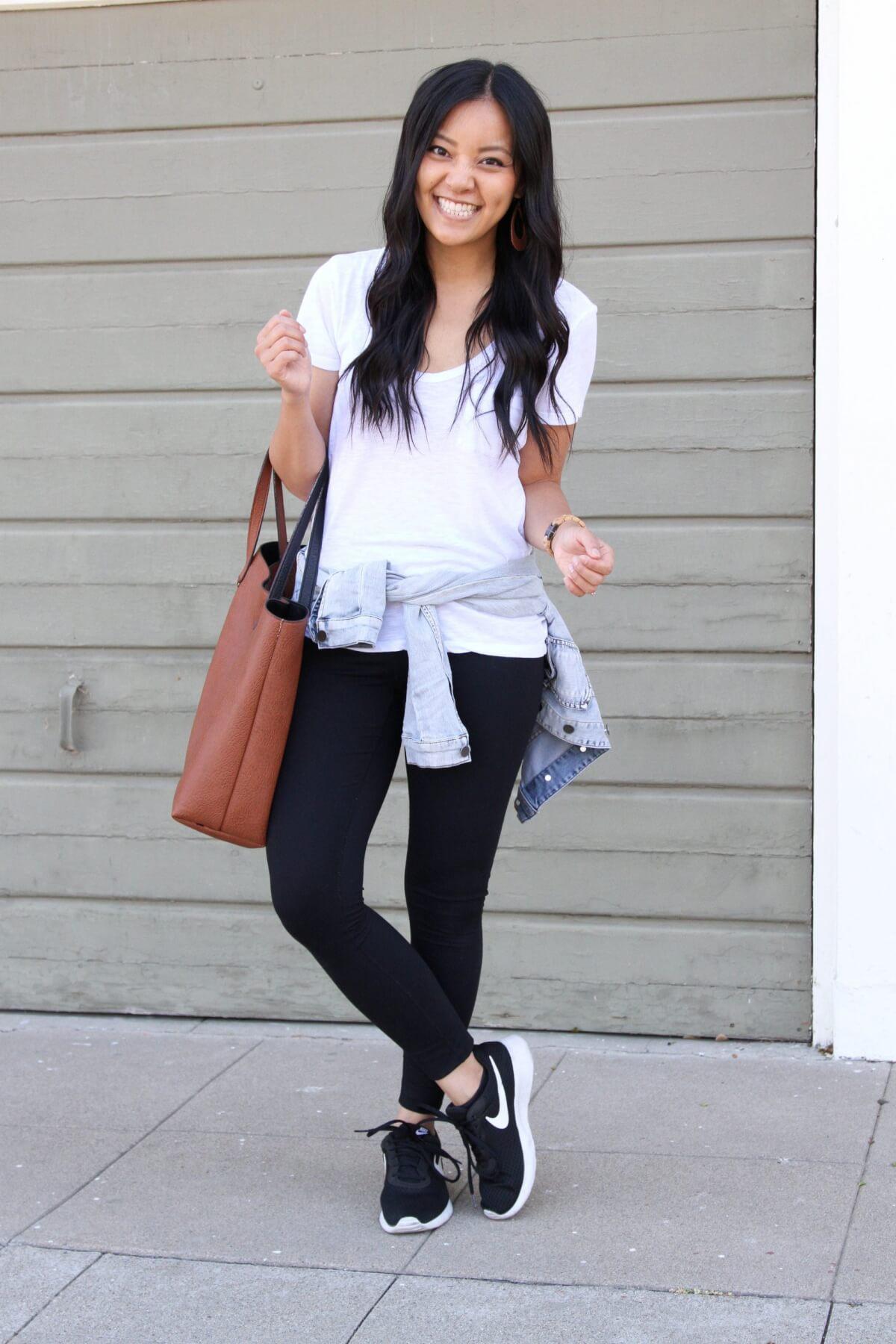 denim jacket outfit: denim jacket + white tee + black leggings + black sneakers + tan earrings + brown tote