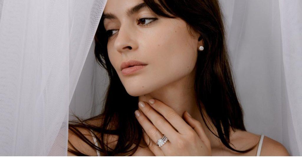 model wearing stud earrings and stacked rings