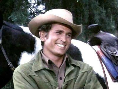 Picture of Landon in Costume. Brunet man with a huge smile, a white hat, and a green jacket.