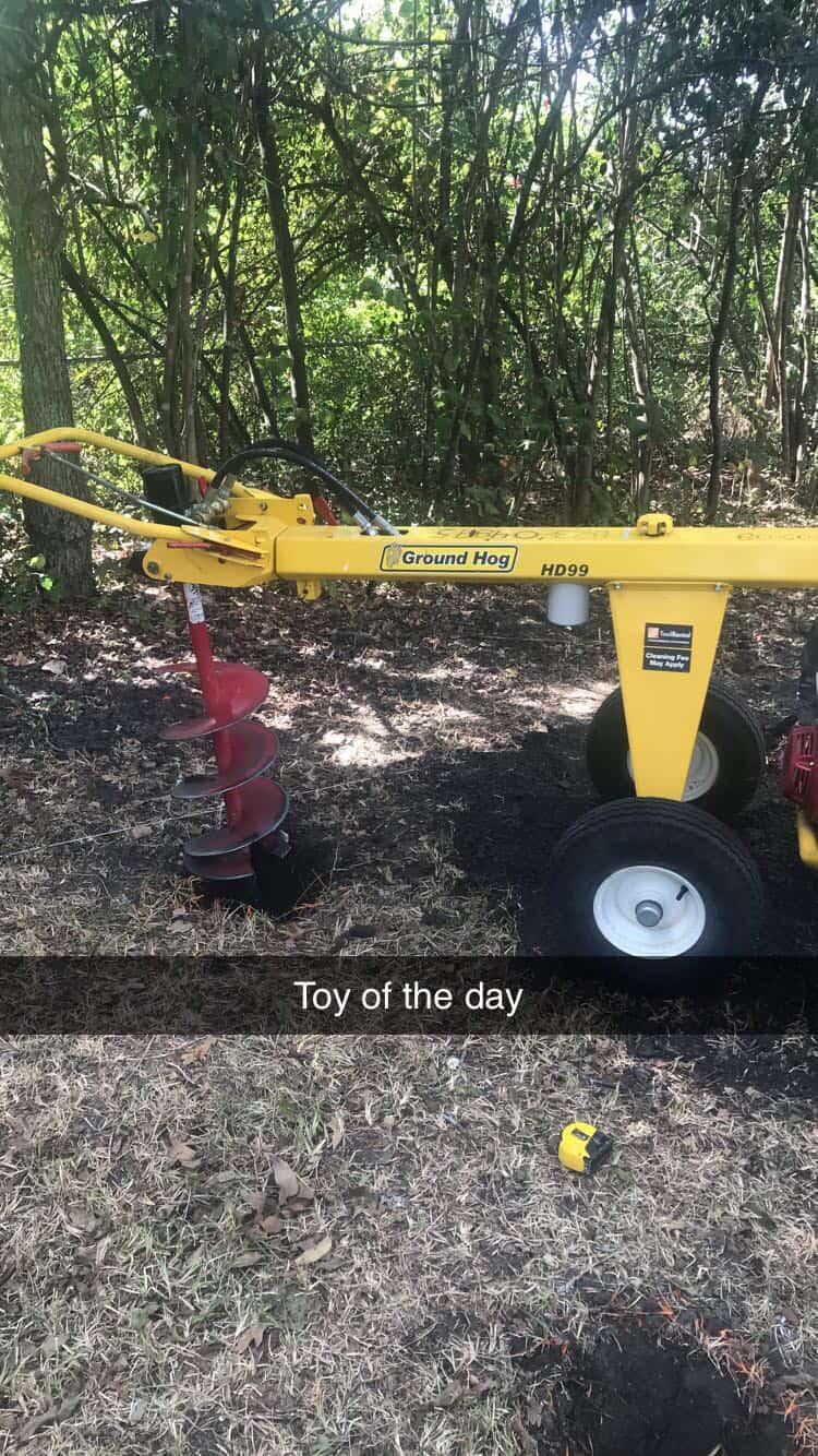 Auger drilling hole in earth