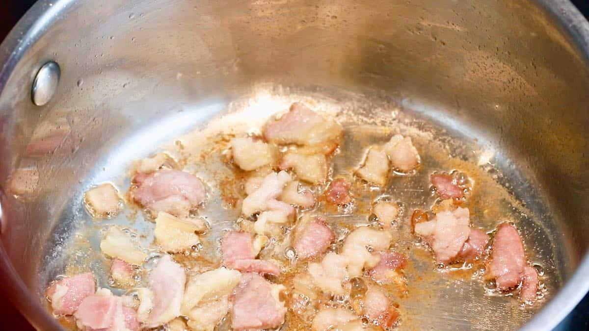 Salt pork cooking in a saucepan.