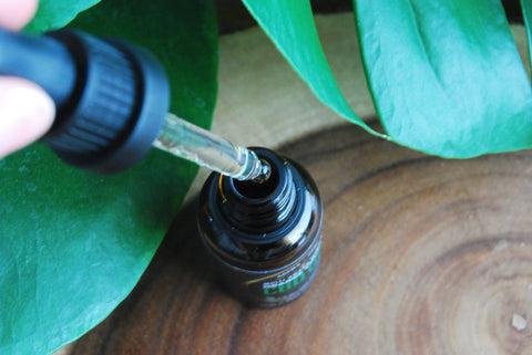bottle of cbd oil on botanical background