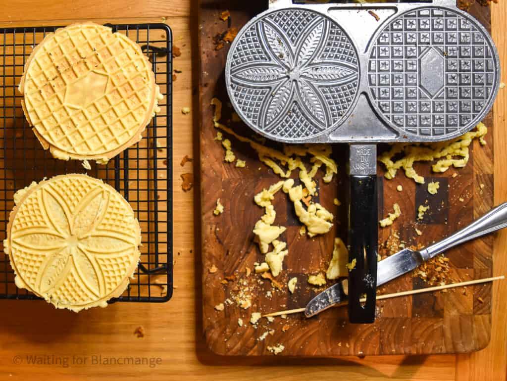 Pressed pizzelle removed from the iron and laid on a wire rack to cool.