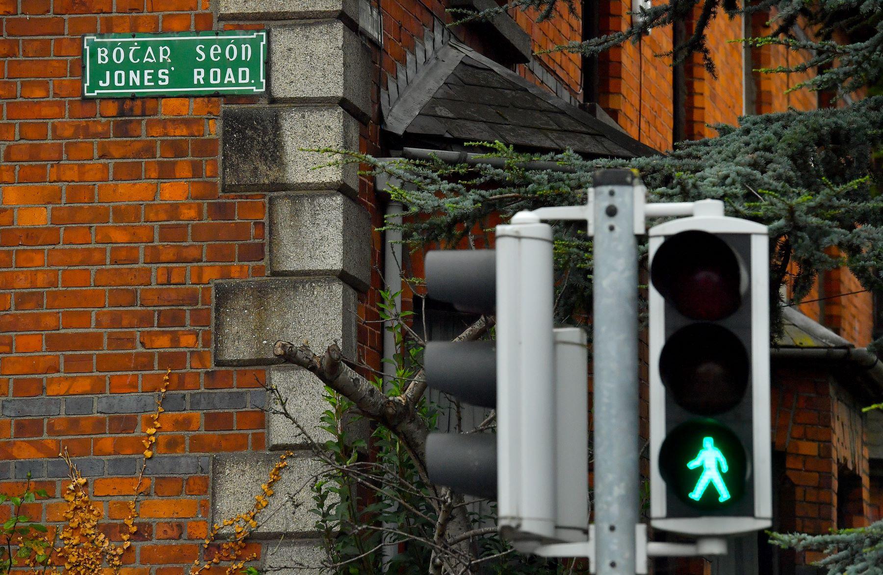 A traffic light with a green walk signal on Jones