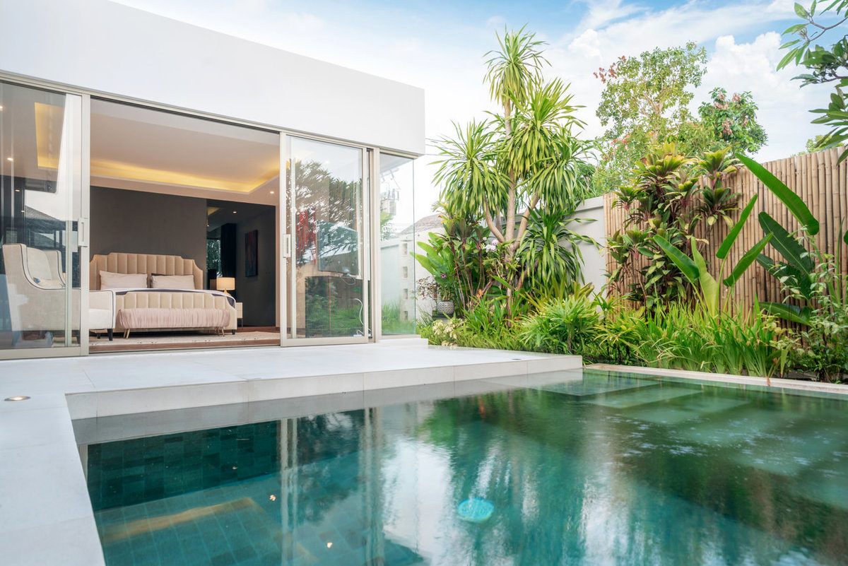 Saltwater pool built in a backyard with a concrete deck