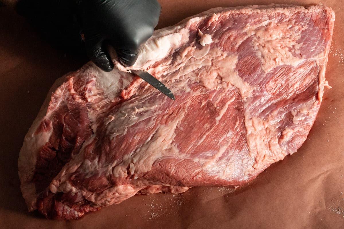 trimming a brisket before we smoke it