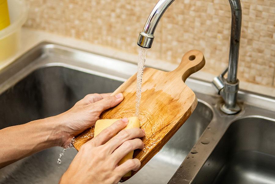 tap water running onto a wood charcuterie board