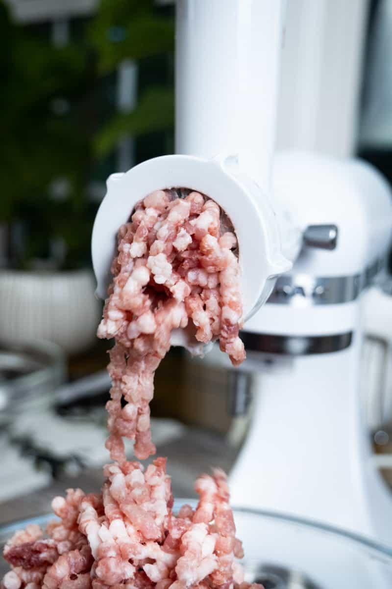 pork falling out of the meat grinder