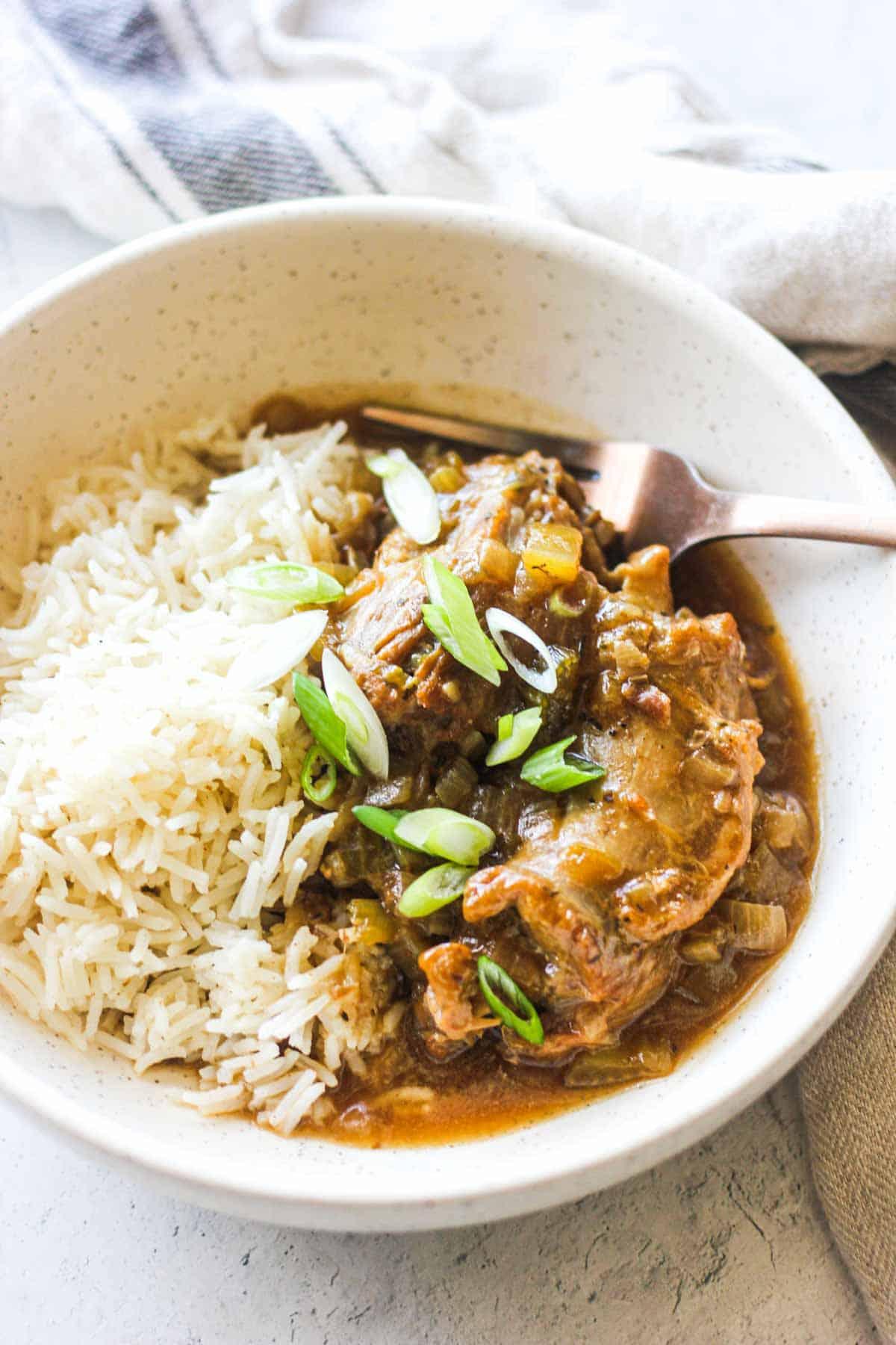 turkey necks with rice and chopped green onions on top