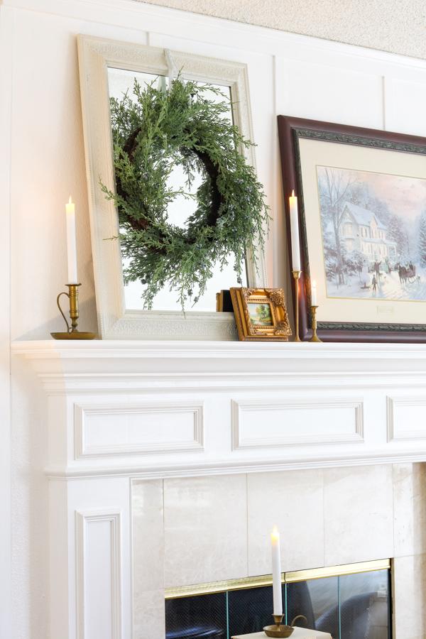 hanging a wreath on a mirror with a ribbon