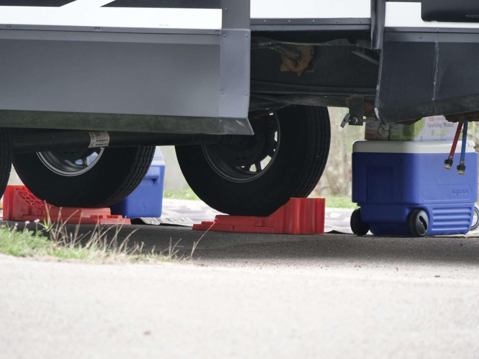 Close up of RV wheels on leveling blocks.