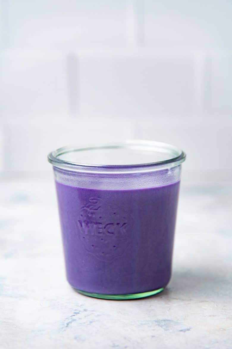 The ube base mixed with milk and placed in a glass jar for storage