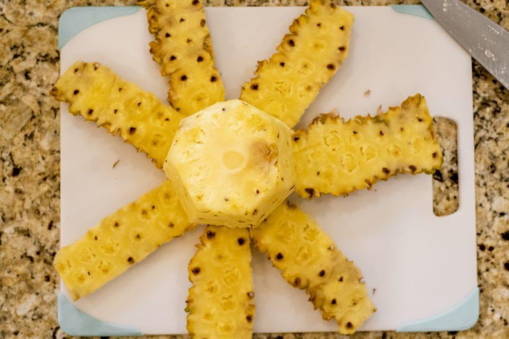 pineapple with removed rind on cutting board