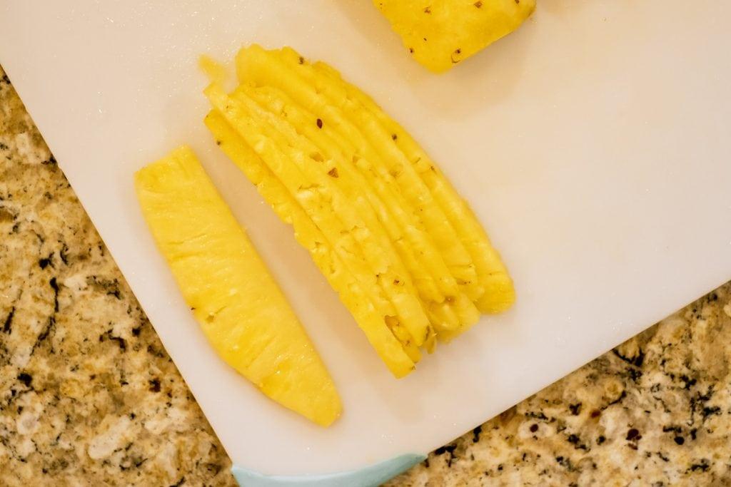 thin slices of pineapple on cutting board