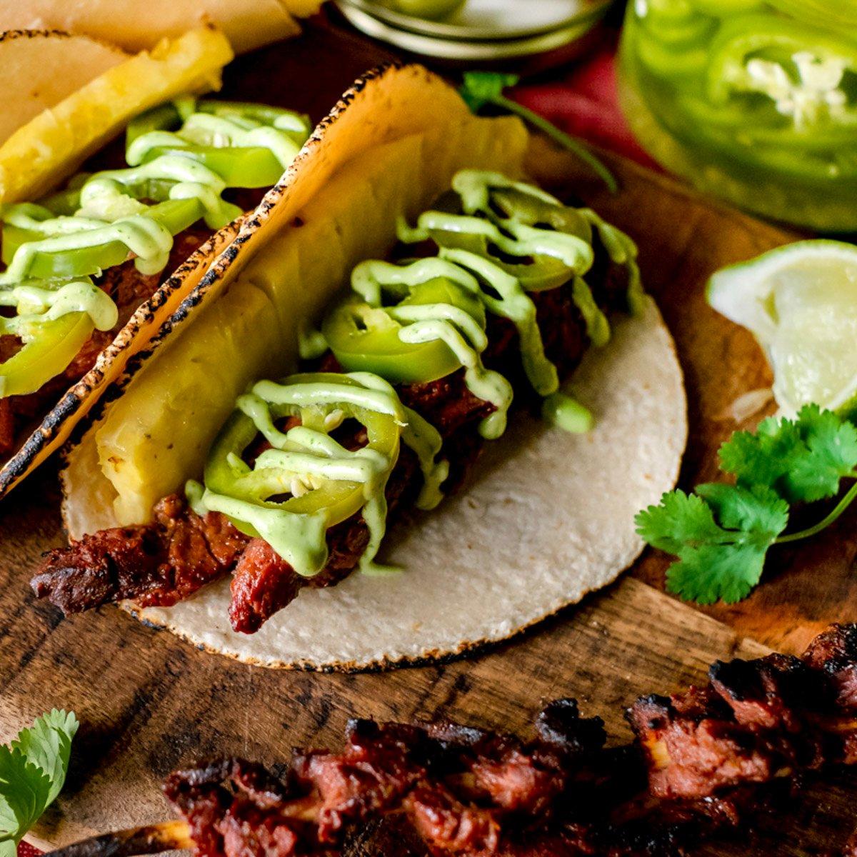 elk heart tacos with jalapenos and avocado crema.