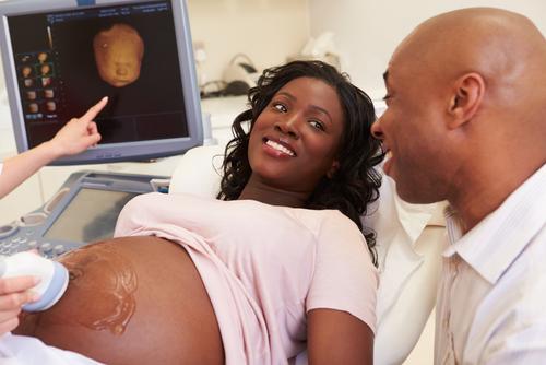 family looks at ultrasound baby