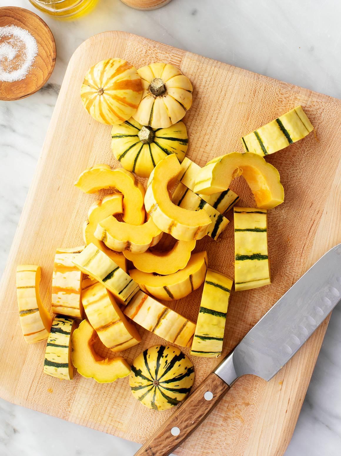 Chopped delicata squash on a cutting board