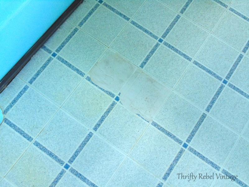 repairing vinyl tile floor by replacing a damaged tile