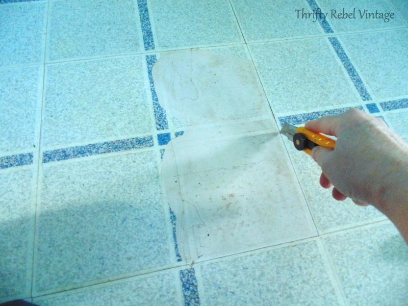 repairing vinyl tile floor by replacing a damaged tile