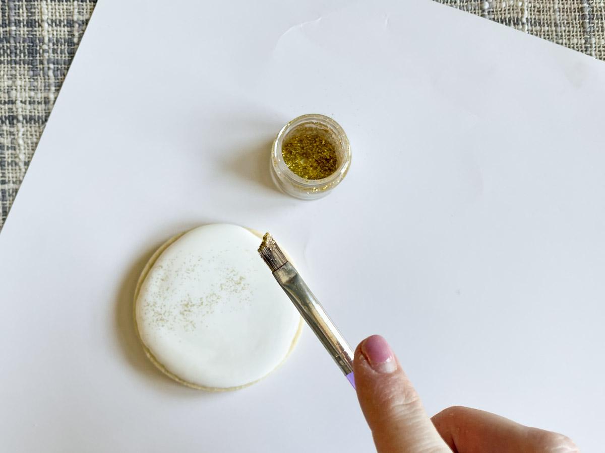 adding edible glitter to royal icing