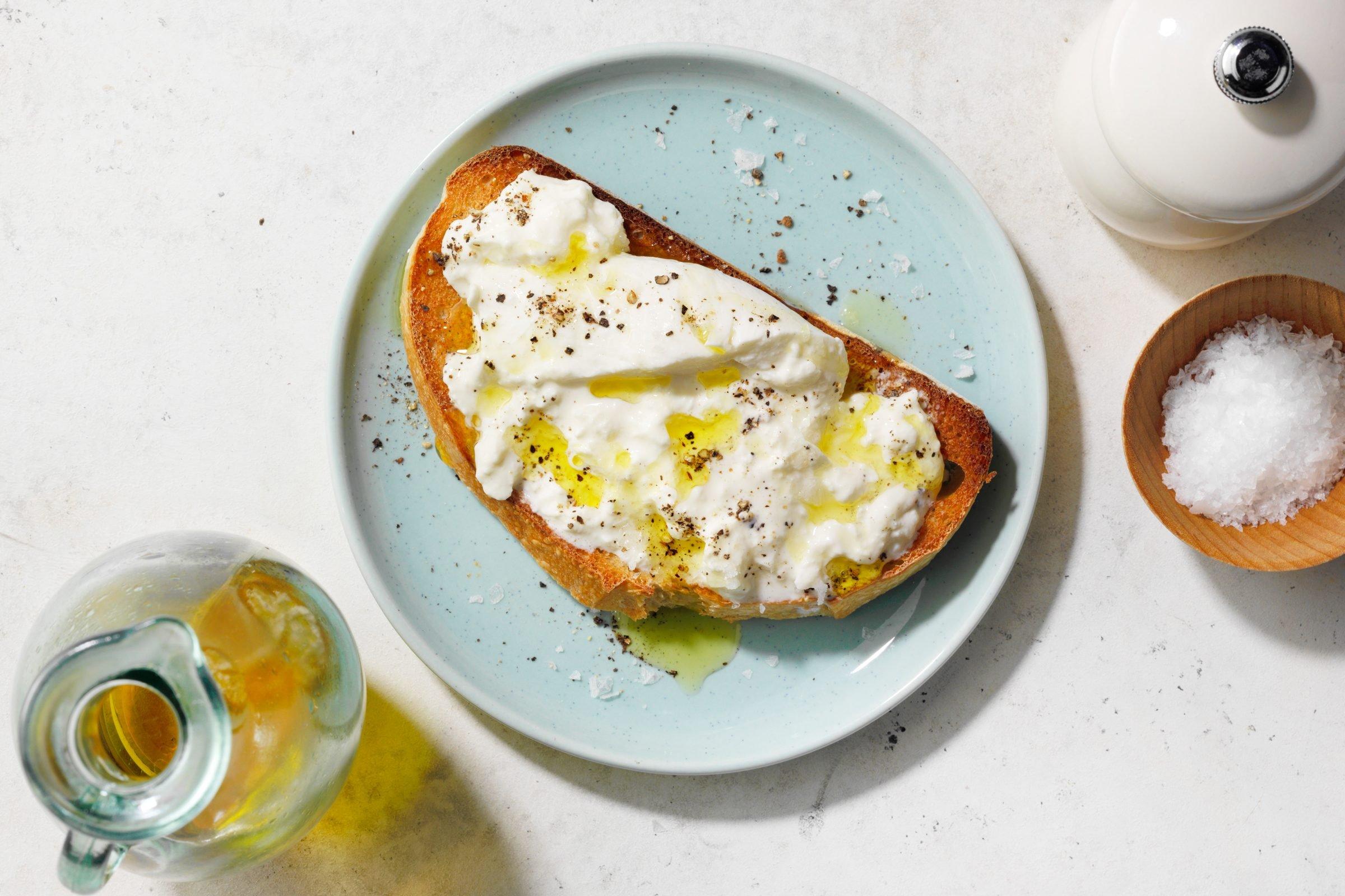burrata toast on a blue plate