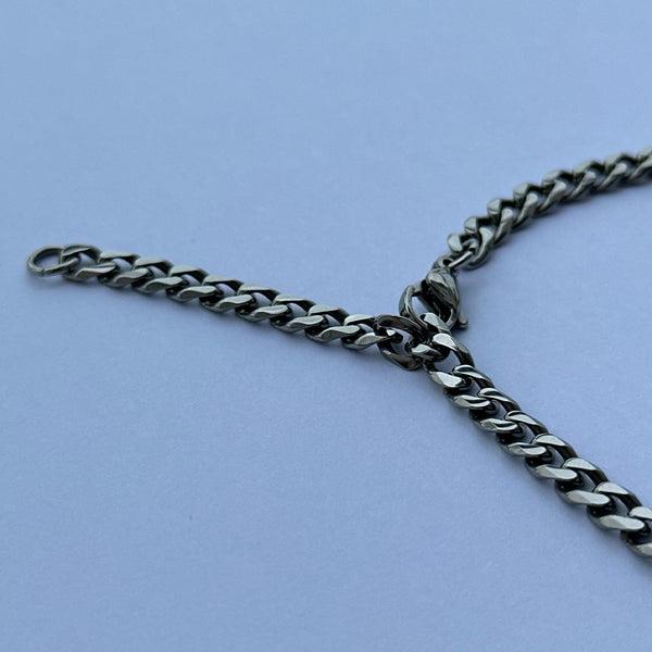 clasping onto a link to shorten a chain necklace