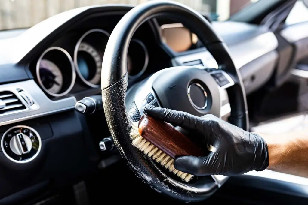 The man cleans the steering wheel with specialized care products