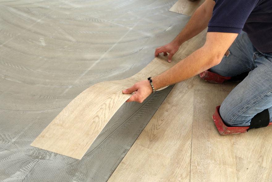 laying flooring worker installing