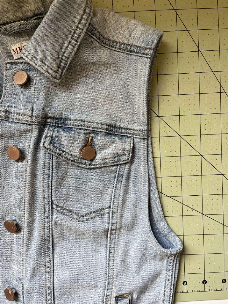 showing pliers taking off denim button