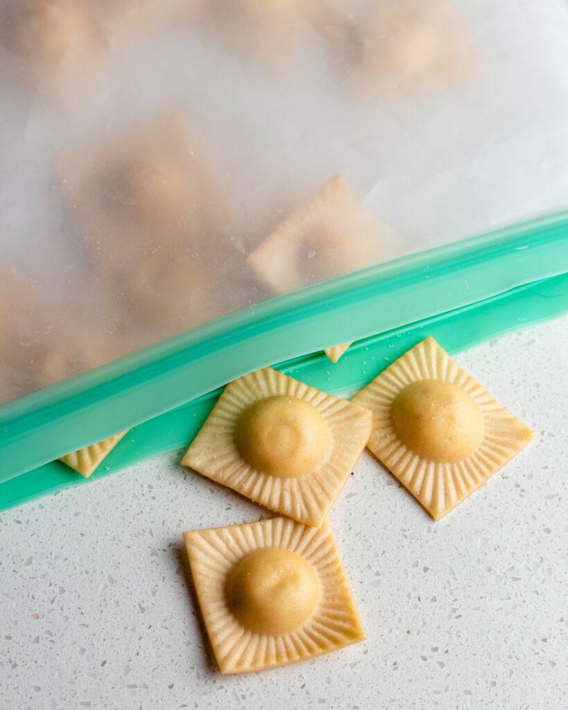 Dried ravioli in a freezer bag on a bench.