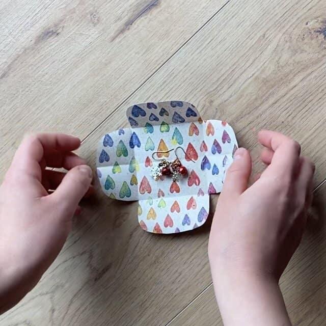 Wrapping loose jewelry pieces in a DIY small package.