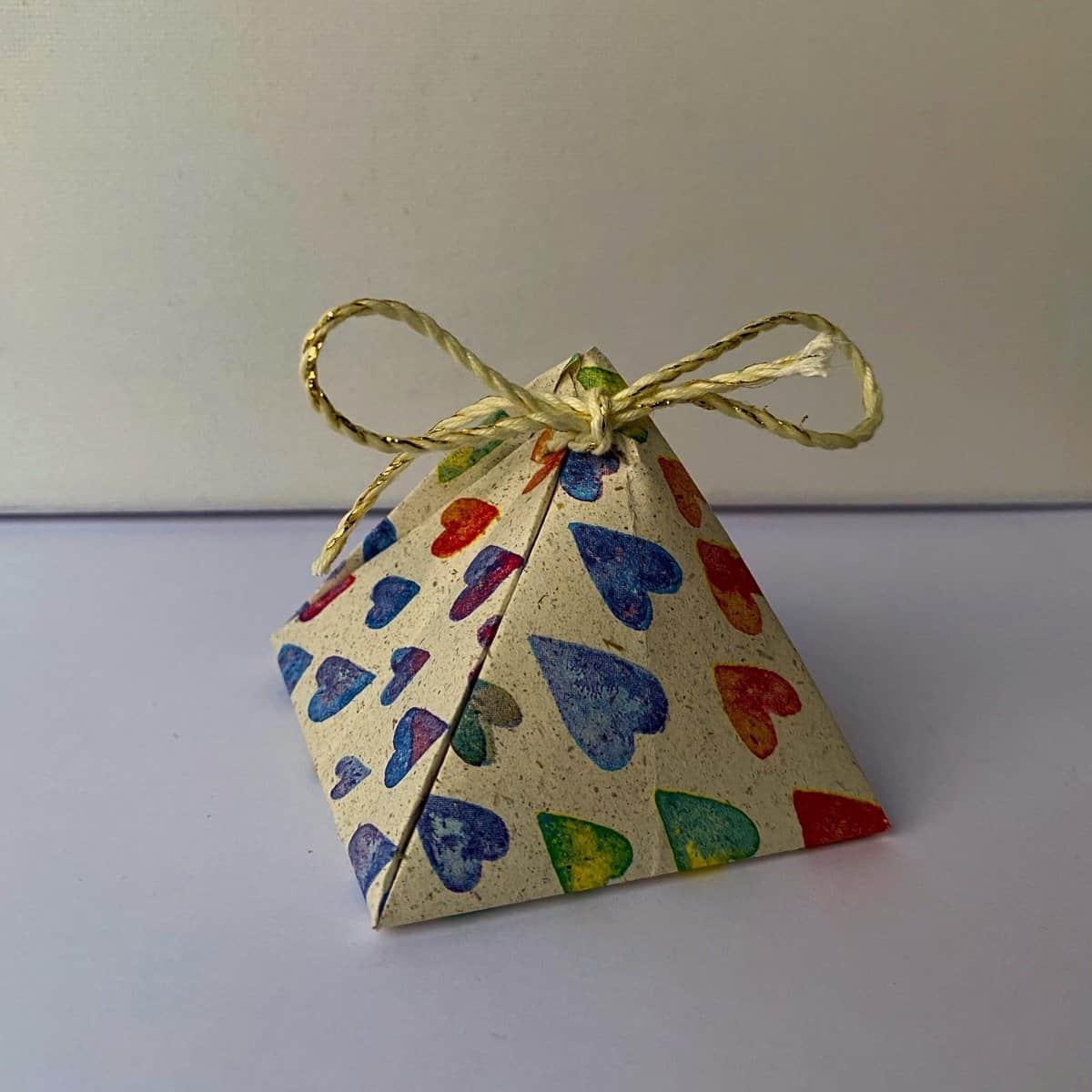 Wrapping loose jewelry pieces in a DIY gift pyramid.